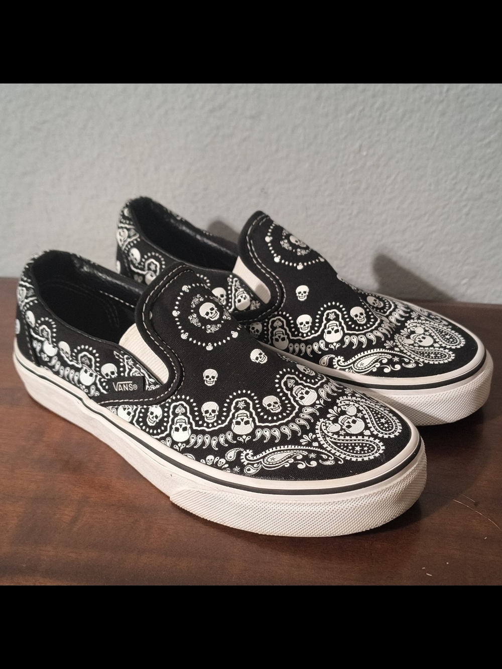 Vans Black & White Slip-On Sneakers with Skull Bandana Print